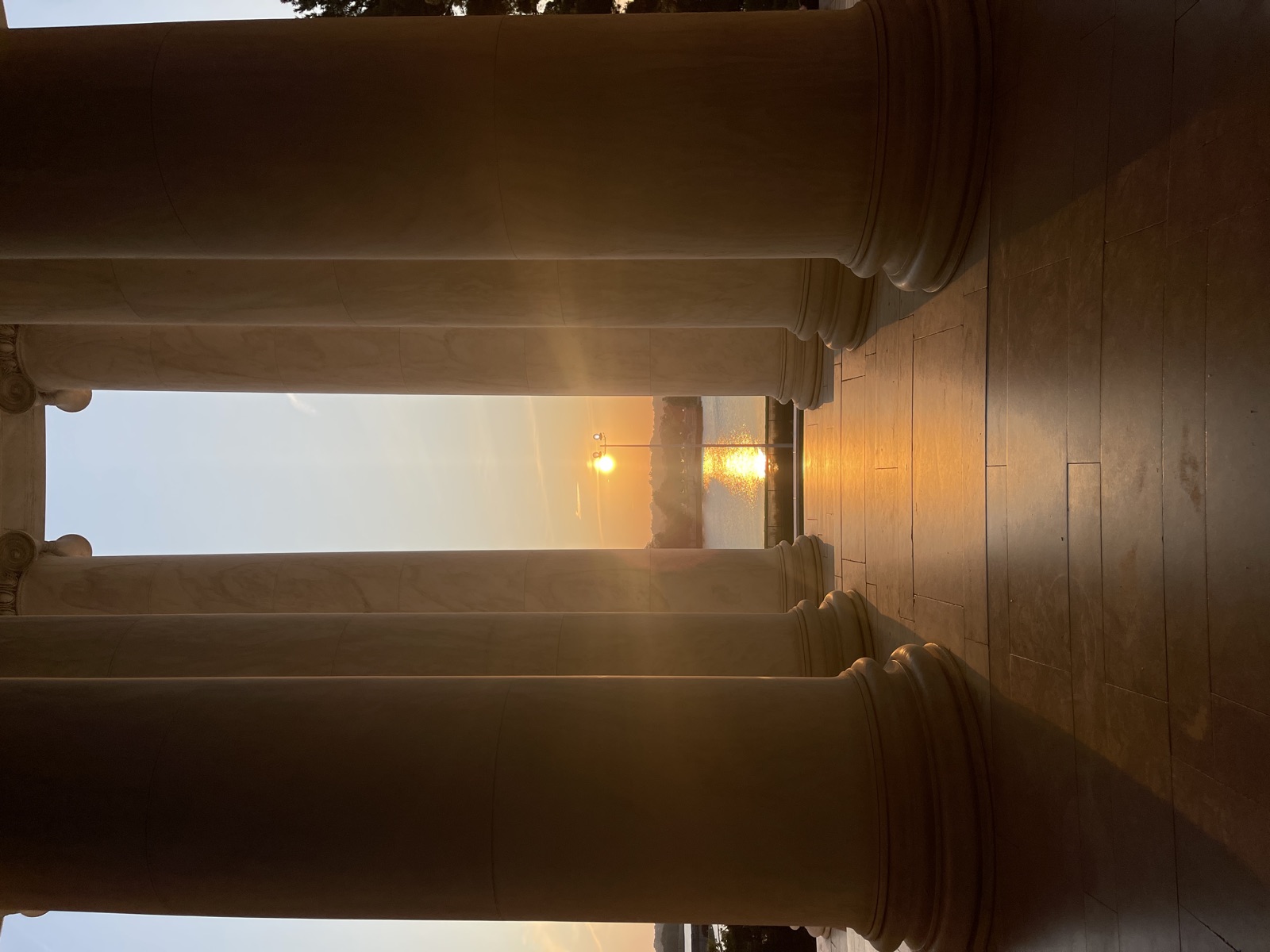 Sunset over the Tidal Basin framed between the Jefferson Memorial's marble columns